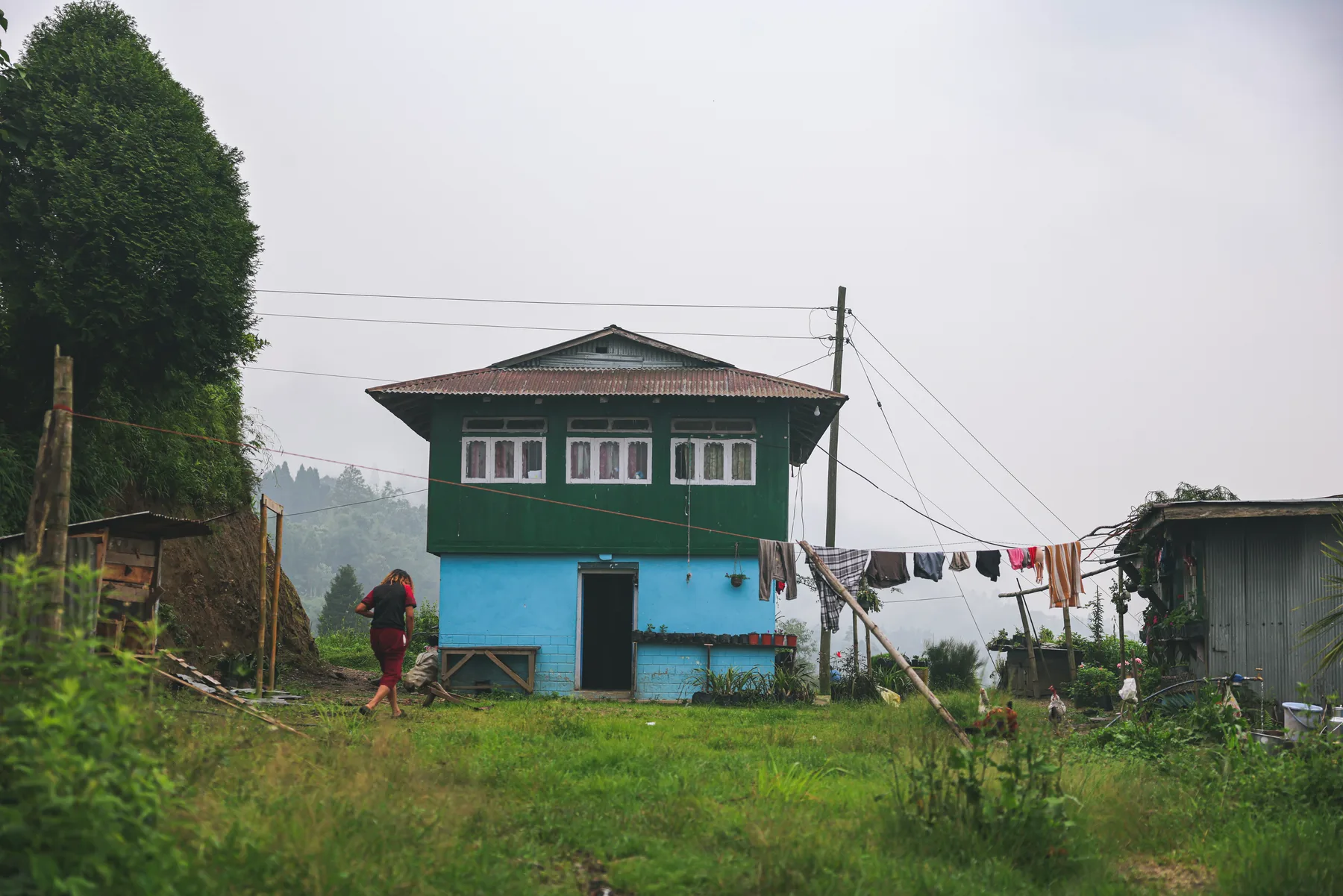 A colourful rural house on a misty walking route