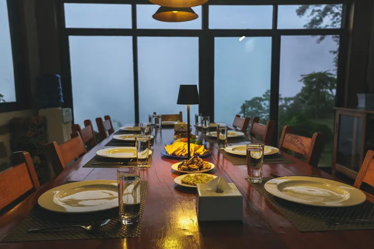 A welcoming shared dining table set for an evening meal