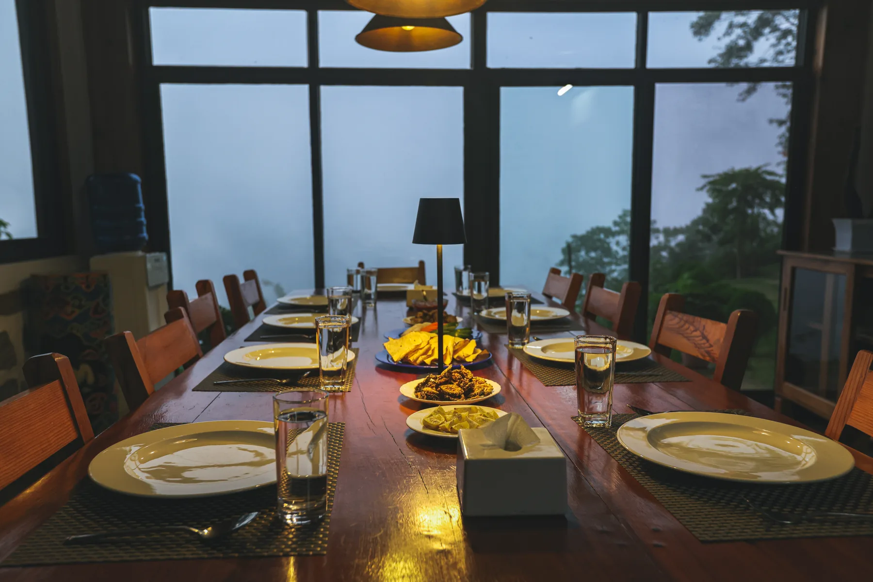 A welcoming shared dining table set for an evening meal