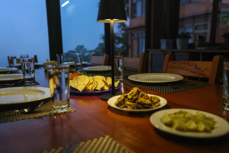 Dinner dishes and glasses in the warm light of Suryodaya Kitchen