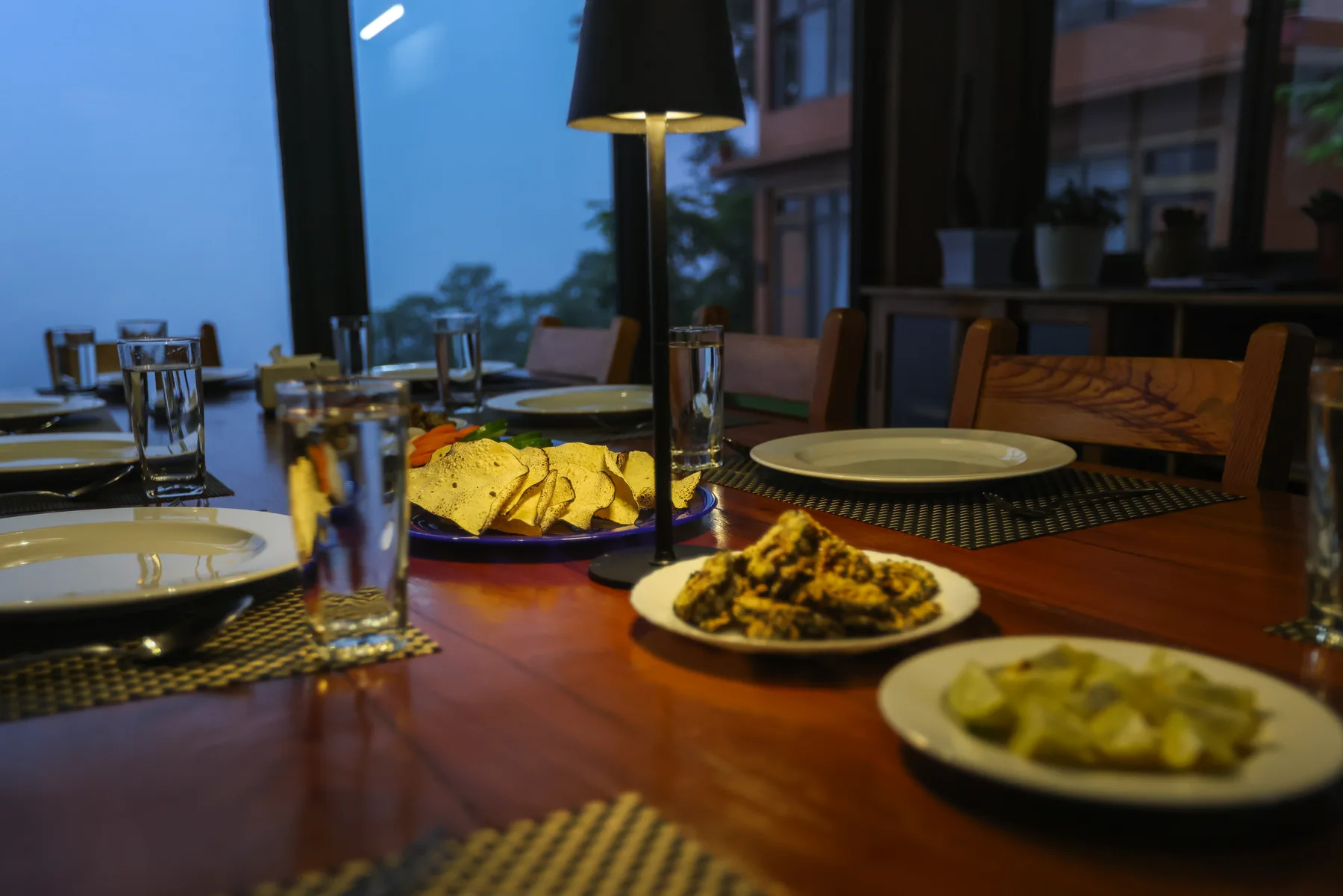 Dinner dishes and glasses in the warm light of Suryodaya Kitchen