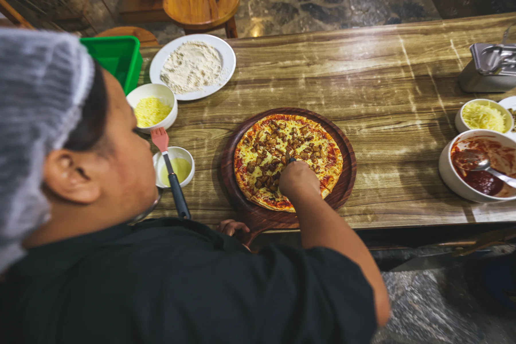 A member of the kitchen team preparing food with fresh ingredients