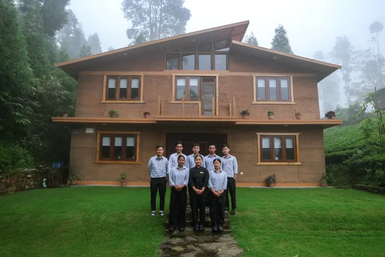 The Sunshine Villa team standing together in front of the villa house