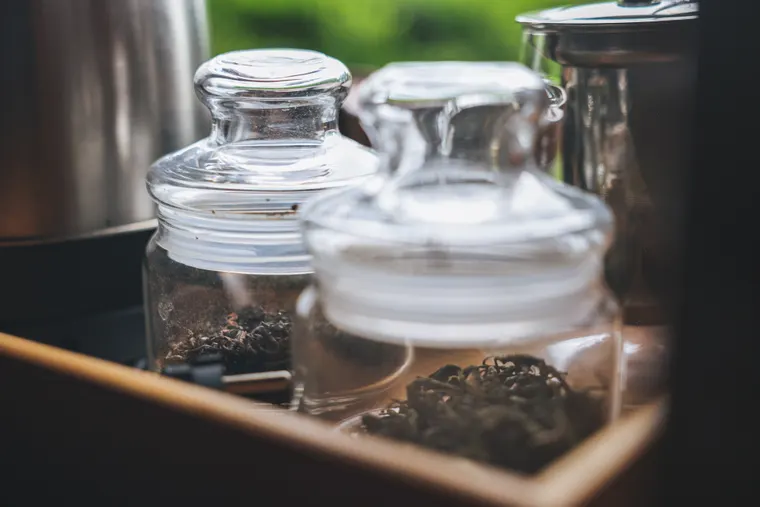 Glass tea jars arranged on a wooden hospitality tray