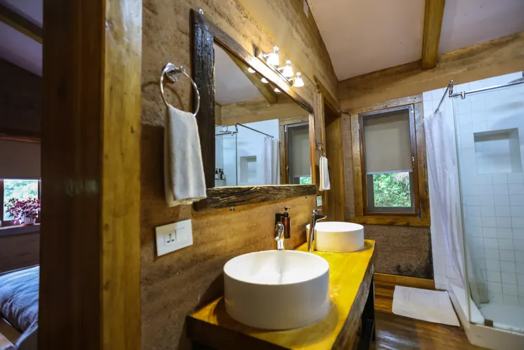 An en-suite bathroom with twin basins, a mirror and shower