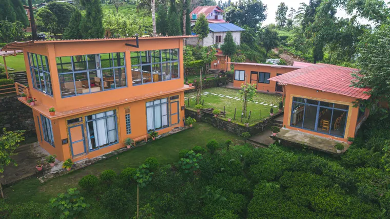Large windows and red roofs across the villa buildings