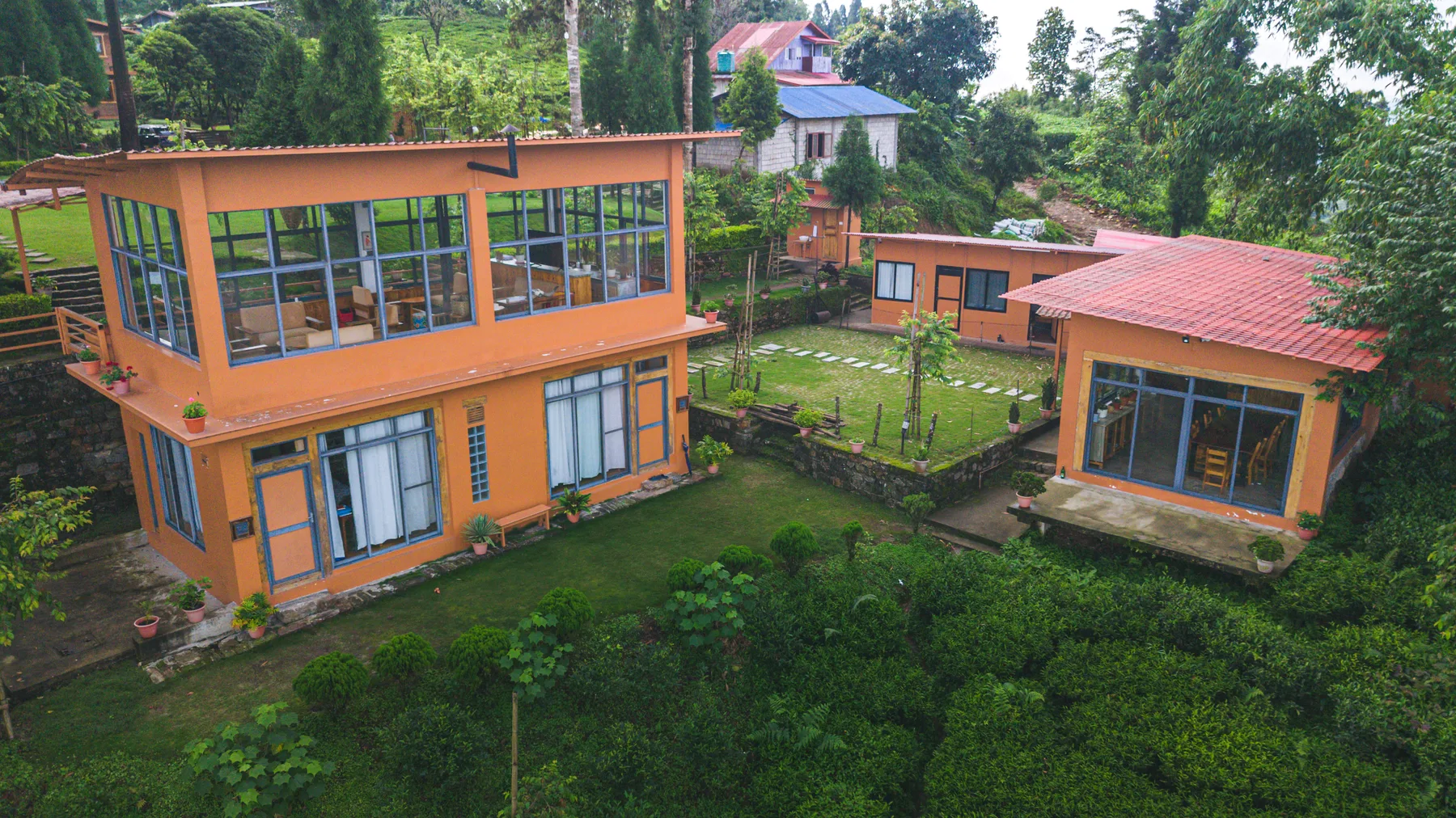 Large windows and red roofs across the villa buildings
